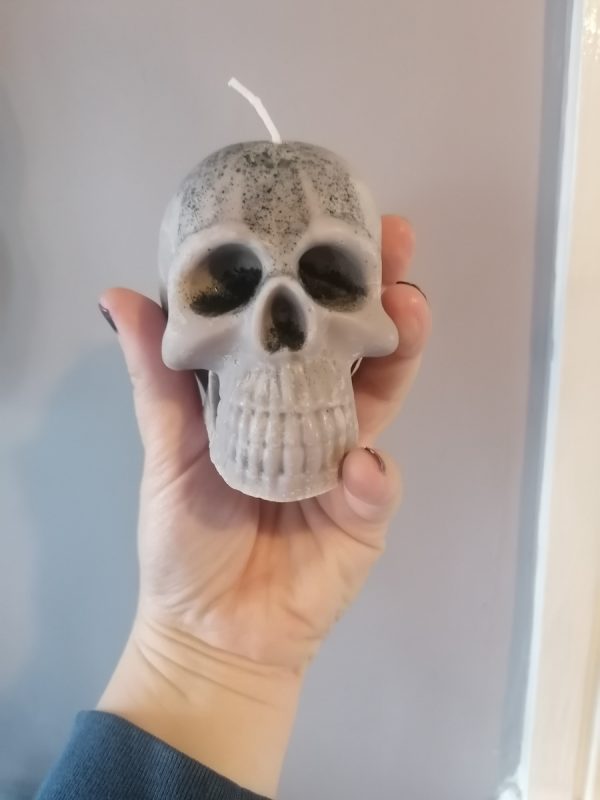 Woman holding a skull candle in her hand