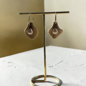 Handmade warm sand polymer clay petal earrings with pearl drops on a gold stand.